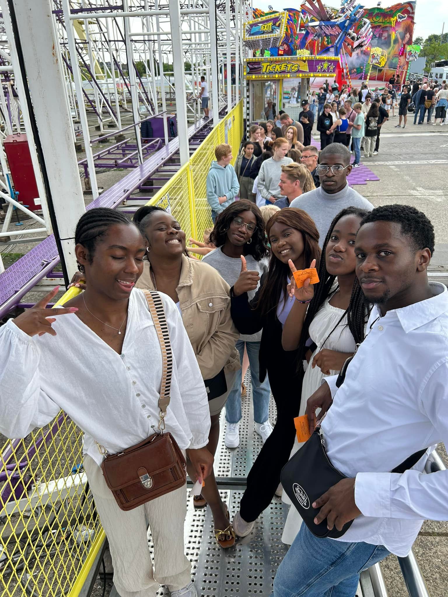 Alt Text: "Group of young adults enjoying a day out at an amusement park." Title: "Fun Day Out with Friends at the Amusement Park