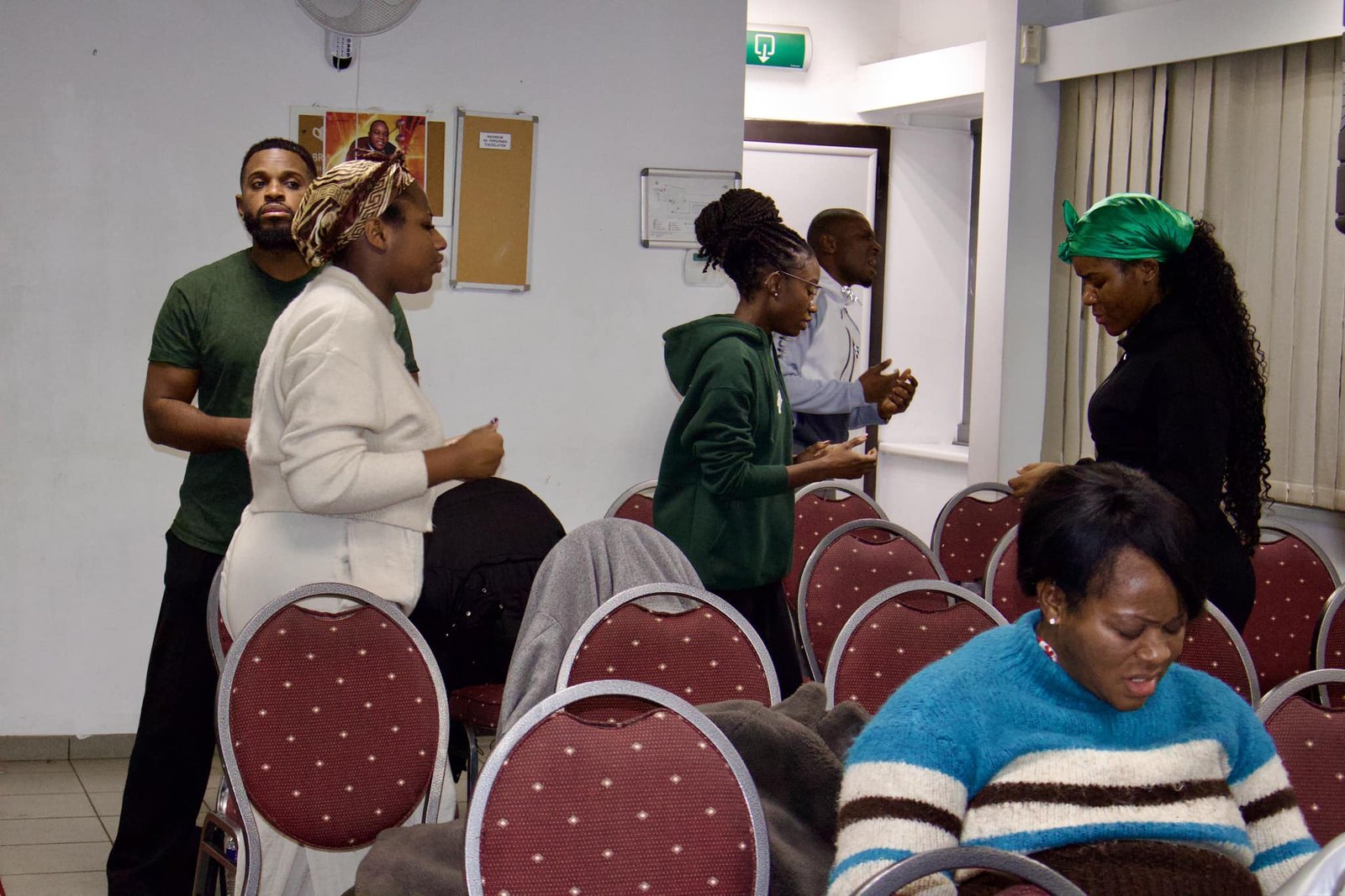 Church members interacting during a break at Église La Bonne Semence