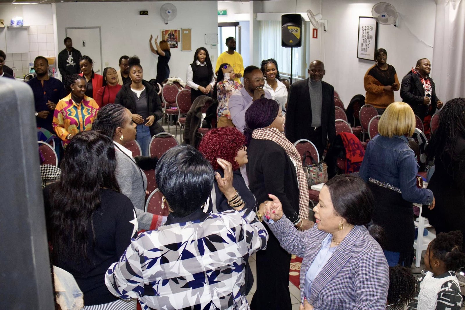 Congregation members of Église La Bonne Semence participating in a vibrant worship service