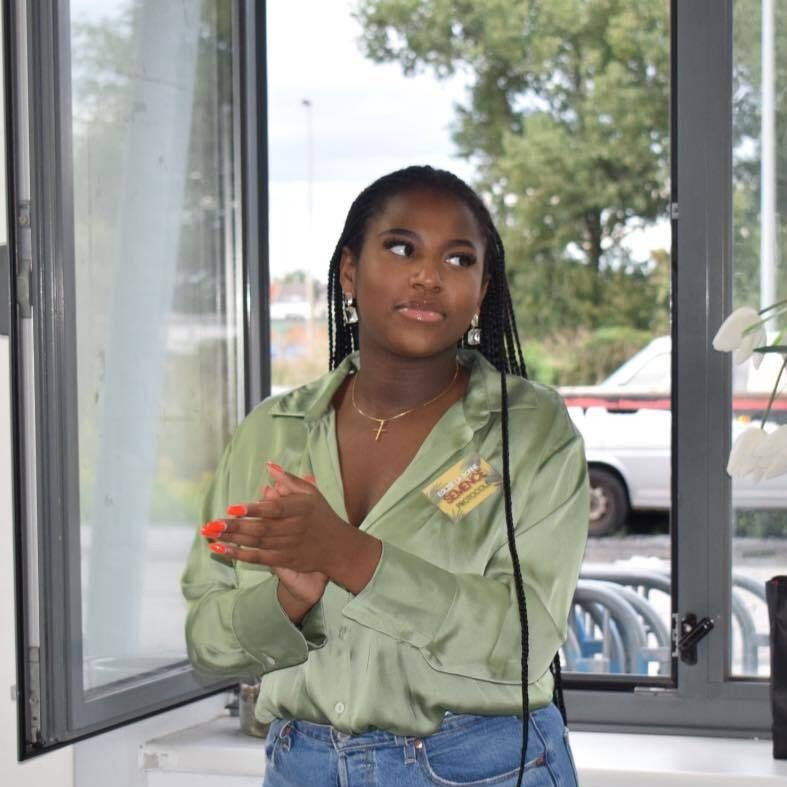 Portrait of Lesley Luzolele standing by a window.