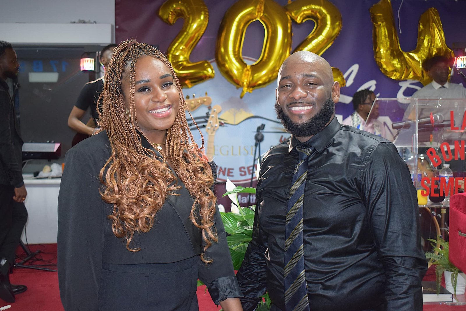 Pastor Dave Mukendi and his wife Deborah smiling at a New Year's celebration at Église La Bonne Semence.