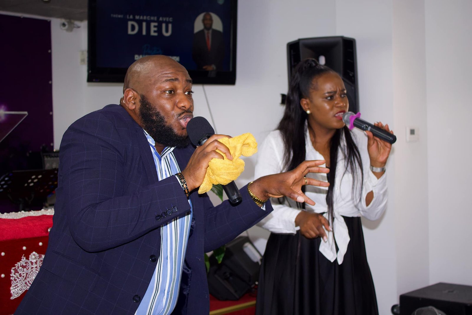 Two translators passionately delivering a sermon at Église La Bonne Semence.