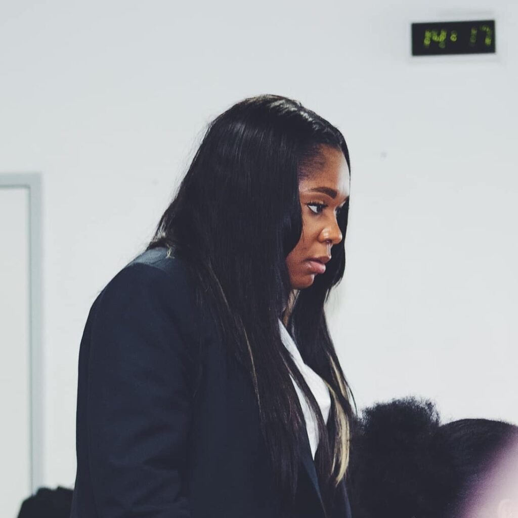 Young woman with long straight hair looking thoughtful during a church service.
