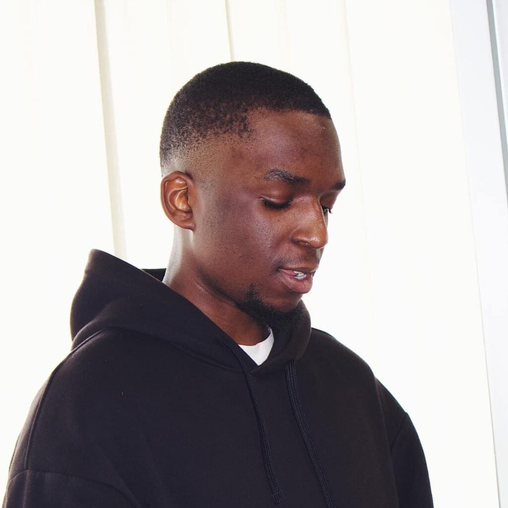 A young man named Jeremy, the drummer, focused on his phone.